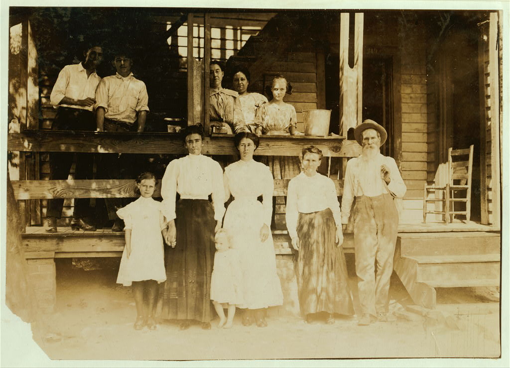 Family of B. F. Clark, 219 N. 4th Street. This family has worked in 8 different mill villages in the past five years. Clark was a prosperous farmer, before that, but his farm ran down. He says mill families get the habit of moving from place to place. "And mills are writing all the time, giving great inducements and trying to fool you too." Some of the families around here have moved much more than we have. Moving eats up a heap of money." The father and all in group except mother and baby are in the mill. Home bare and ill-kept. Location: Columbus, Mississippi.1911