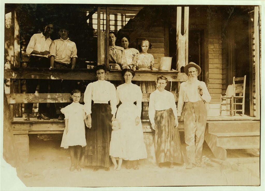 Family of B. F. Clark, 219 N. 4th Street. This family has worked in 8 different mill villages in the past five years. Clark was a prosperous farmer, before that, but his farm ran down. He says mill families get the habit of moving from place to place. "And mills are writing all the time, giving great inducements and trying to fool you too." Some of the families around here have moved much more than we have. Moving eats up a heap of money." The father and all in group except mother and baby are in the mill. Home bare and ill-kept. Location: Columbus, Mississippi.1911
